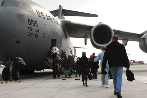 Space-A travellers are loaded into a C-17